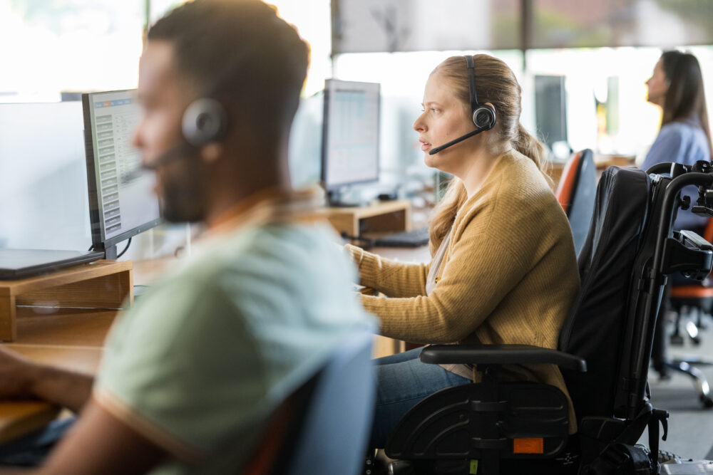 Determined Businesswoman in Wheelchair at Workstation