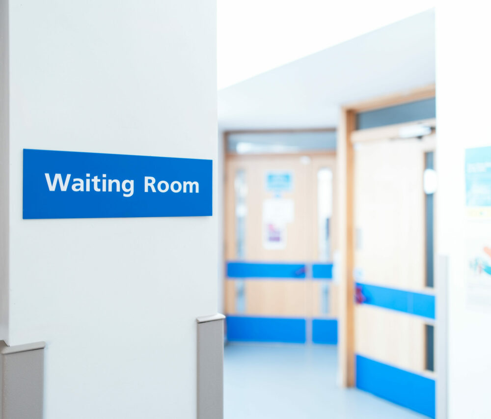 hospital corridor with a focus on waiting room sign